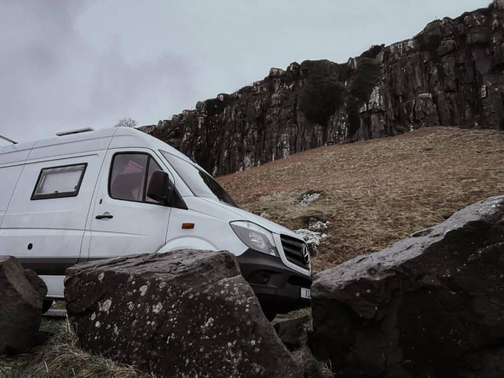 Converted Mercedes Sprinter Campervan, sat by the coast in the moody Isle of Skye, Scotland.