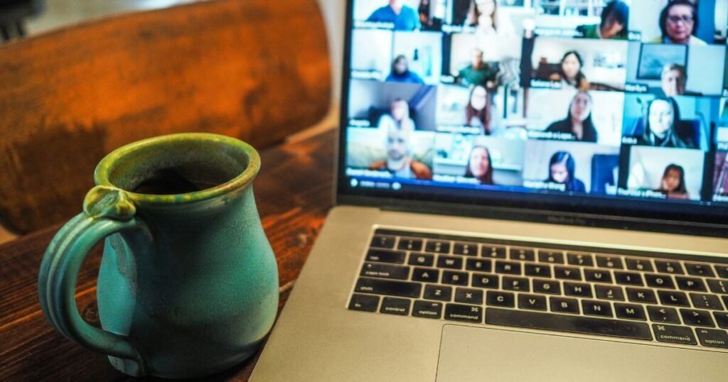 Laptop screen filled with members of an online meeting.