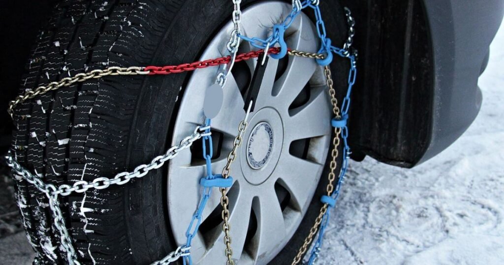 A close of picture of snow chains on a tire. A winter vanlife essential. 