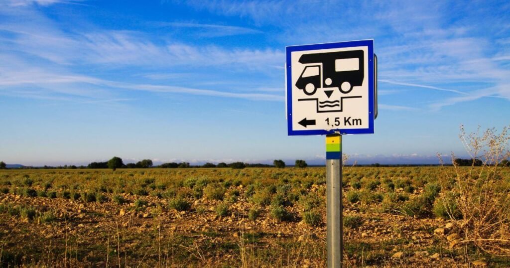 Camper Van Toilets: A road-side sign, in the middle of the countryside, for a camper van dumping station thats 1.5 kilometers away