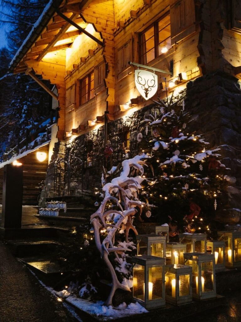 CERVO Mountain Resort reception chalet decorated with antlers and covered in snow. CERVO is a great place to stay, eat and play in Zermatt at Christmas time. 