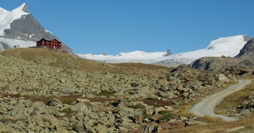 Where to stay in Zermatt - Best mountain huts in the summer, Fluhalp Mountain Hotel, sat amongst the snow capped peaks.